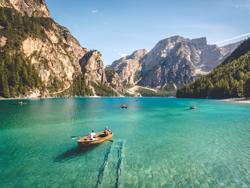 Canoes and a wooden dock on a still camp lake.